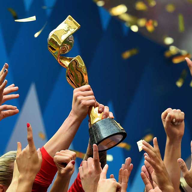 Women’s world cup trophy being held up in the air